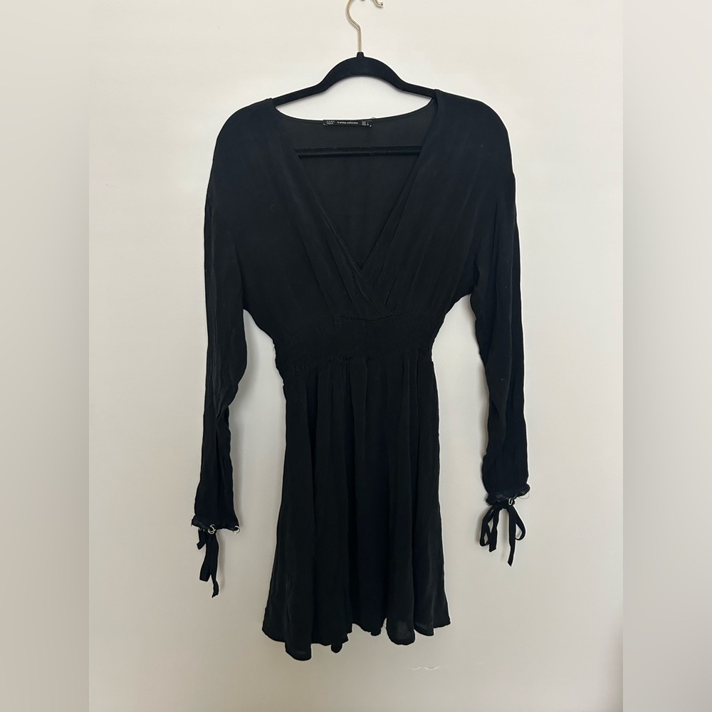 Zara long sleeve, short black dress with silver rings detailing the cuffs.